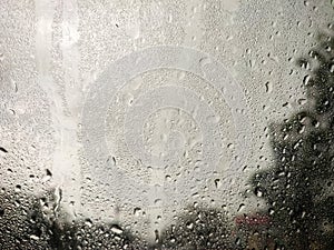 Abstract background of drops of water flow down at windshield