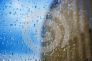 Abstract background. Drops of water on the window. High-rise buildings.