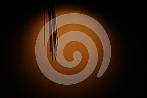 Abstract background with dull orange circle against dark background with fringe