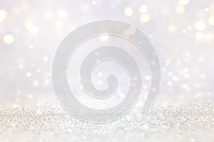 abstract background of glitter vintage lights . silver, gold and white. de-focused