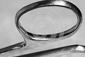 Abstract background with a handle of a nail scissors close-up, soft focus