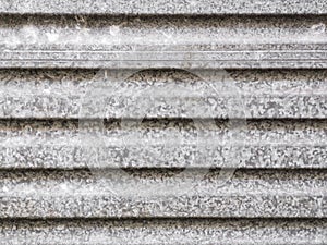 An abstract background image of horizontal galvanised corrugated steel