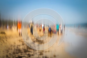 Abstract background image of people walking on the beach in the style of the Impressionists.