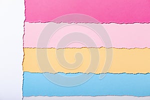 Abstract background of multi-colored stripes of torn cardboard , top view,vouchers for writing reminders, concept office and photo