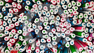 Abstract background of multicolored caps of plastic pens. A set of several liners, markers and colored markers of