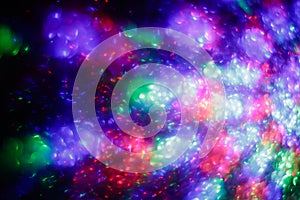 Abstract background with night lights. Festive backdrop. Creative colorful space. Defocused bright disco lights. Illuminated blurr