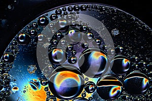 Abstract background of oil bubbles in low key with different colors