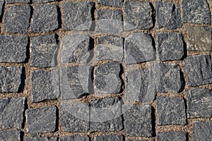 Abstract background. Old cobblestone pavement close-up.