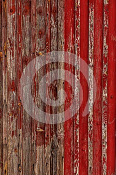 Abstract Background of old painted wood. Wooden fence with traces of old cracked faded paint on the wood surface