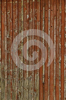 Abstract Background of old painted wood. Wooden fence with traces of old cracked faded paint on the wood surface