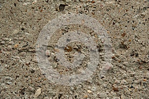 Old rough texture, gray concrete wall with cracks and small stones.