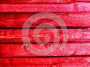 Abstract background with old wooden boards painted with red paint with texture and knots. Pattern, place for text and