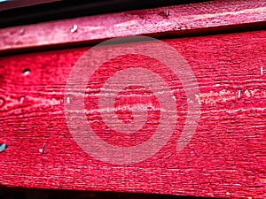 Abstract background with old wooden boards painted with red paint with texture and knots. Pattern, place for text and