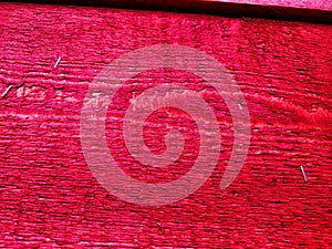 Abstract background with old wooden boards painted with red paint with texture and knots. Pattern, place for text and