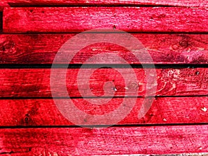 Abstract background with old wooden boards painted with red paint with texture and knots. Pattern, place for text and