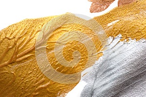 Abstract background painted with a brush of gold and silver paint