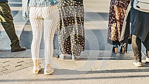 Abstract background of people standing on crosswalk, getting ready to cross road at city street