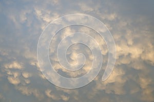 Abstract background curly clouds on blue sky