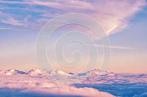 Abstract background with pink, purple and blue colors clouds. Sunset sky above the clouds.