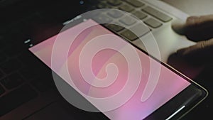 Abstract background of pink waves on smartphone screen. Rays of light come from screen. Male hand flapping with fingers