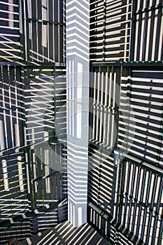Abstract background of play of light and shadow  through ventilated wall panels in the hallway of the villa in tropics
