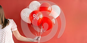 Abstract background with product discount promotion ideas. Woman hand swarming red and white balloons