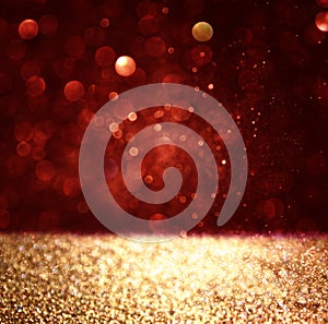 Abstract background of red and gold glitter bokeh lights, defocused