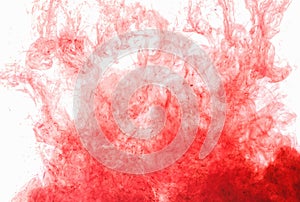 Abstract background. Red ink in water, in motion. Color drop swirling. Colorful cloud of paint on white.