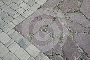 The inner yard is paved with decorative stone. Stone pavement, paved rectangular red blocks. A stone pavement.