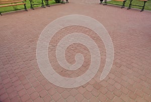 The inner yard is paved with decorative stone. Stone pavement, paved rectangular red blocks. A stone pavement.
