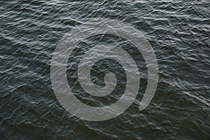 Abstract background of river water flow under the influence of light. The texture of the water