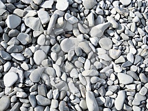 Abstract background with round peeble stones on sunny day