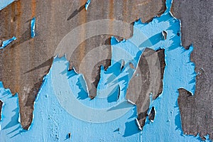 Abstract background. Rusty metal surface with old peeled blue paint.