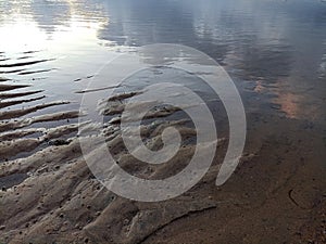 Abstract background of the sand and sky clouds water reflection in blue and gray colors. Natural backgrounds of sand texture.