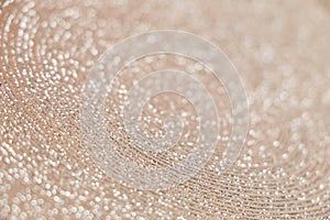 Abstract background of shiny rings of gray, black and beige colors with iridescent glitter