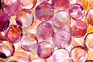 Abstract background with shiny water balls in violet and orange colors