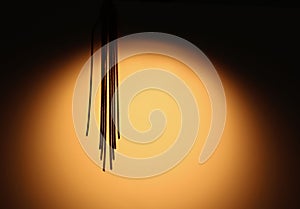 Abstract background showing fringe hanging down in gold circle with copyspace