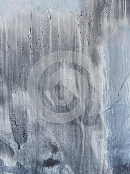 Abstract background showing a textured grey wall with streaks of dirt and grime photo