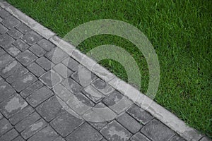 Abstract background with sidewalk and green grass. Summer sun footpath garden paving stones landscape country texture track