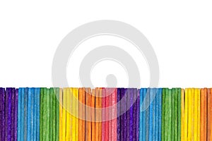 Abstract background, a simple fence border made of ice cream / popsicle sticks alligned in a pattern, a single row isolated