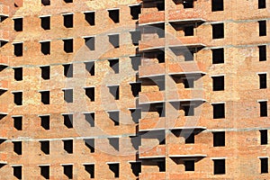 Abstract background of sunlit brick multistory building under construction