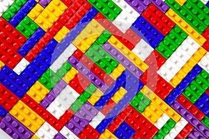 Abstract background texture of colored constructor blocks. Background of colorful plastic part of constructor. Pile of colored toy