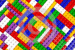 Abstract background texture of colored constructor blocks. Background of colorful plastic part of constructor. Pile of colored toy