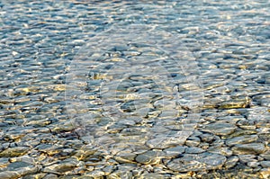 Abstract background texture, Colorful sea stones in water. Wonderful natural background. Clear crystal shallow blue sea