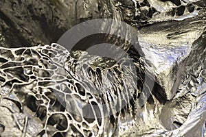 Abstract background or texture from a silver stone with volume dredging. Natural solid material. Black-and-white. Natural mineral.