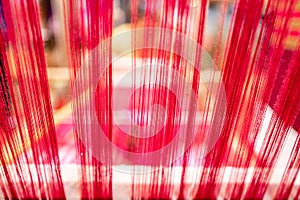 Abstract background of thread on bobbin prepared for weaving.