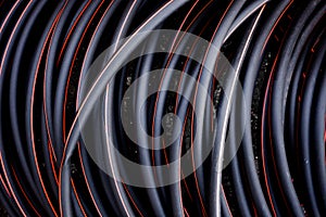 Abstract background of twisted cable red and black color lines