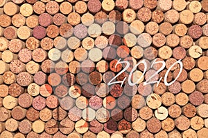 Abstract background of used old wine corks with silhouette of wine bottle and wine glasses