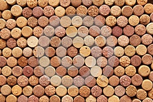 Abstract background of used wine corks with corkscrew