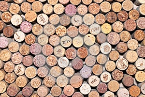 Abstract background of used wine corks with corkscrew marks on corks and calendar dates on some corks